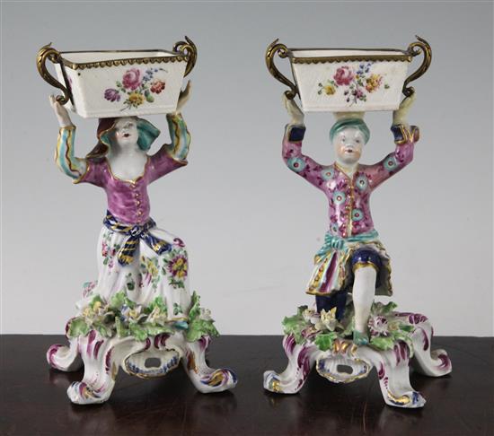 A pair of Bow figural sweetmeat dishes, c.1765-70, height 17cm, restorations